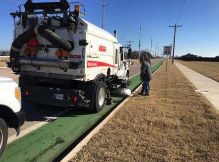 Street sweeper next to bike lane
