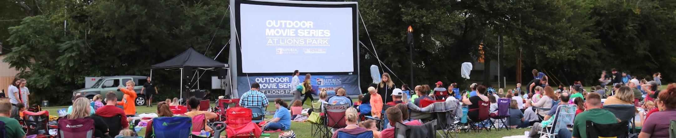 Group Gathering for a Movie in a Park