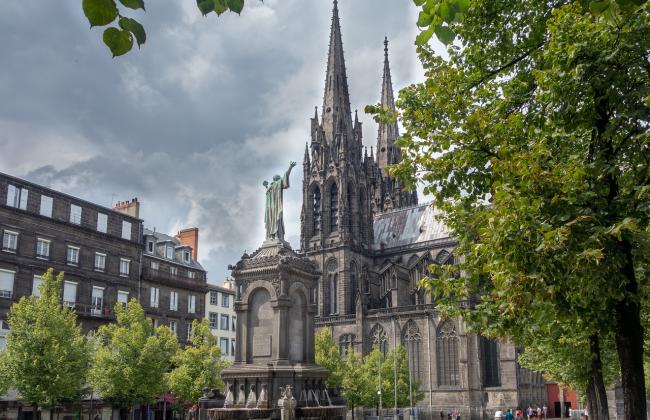 A statue and cathedral in Clermont-Ferrand, France